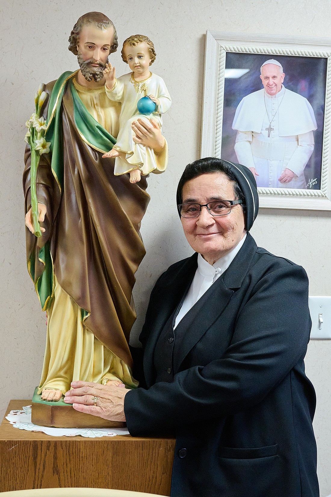 Sister Brunilda Ramos stands with a statue of St. Joseph, the saint to whom she turns over all in prayer, in the St. Joseph by the Sea Retreat House. Mike Ehrmann photo