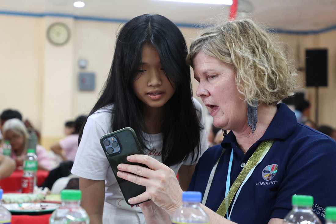 Ashley Hufft, the new president and CEO of Unbound, interacts with Samantha, an 11-year-old sponsored child, during a sponsor awareness trip to the Philippines Feb. 3, 2024. Unbound, based in Kansas City, Kan., is an international nonprofit founded by Catholics to assist the poor and marginalized in 17 countries around the globe. (OSV News photo/courtesy Unbound)