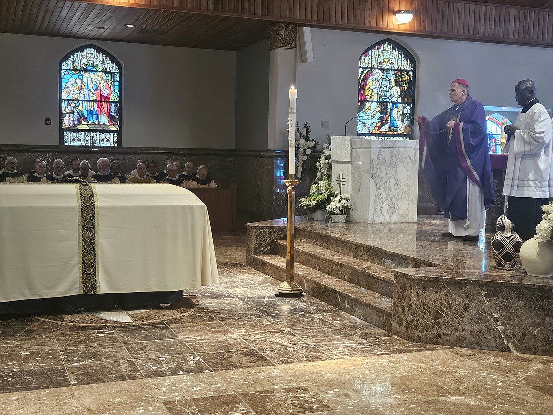 Bishop O'Connell incenses the casket of Father Daniel F. Gowen. Mary Stadnyk photos