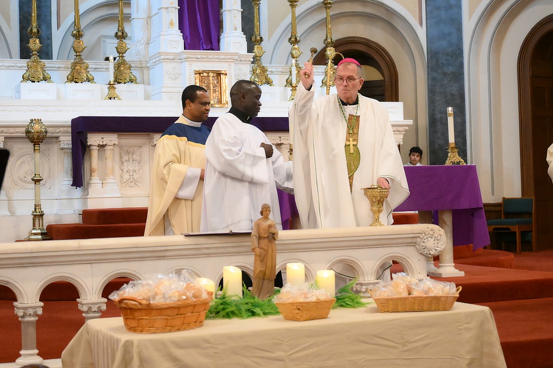 Bishop O'Connell blesses bread following the Mass he celebrated for the Solemnity of St. Joseph, March 19, in Sacred Heart Church, Trenton. Mike Ehrmann photo