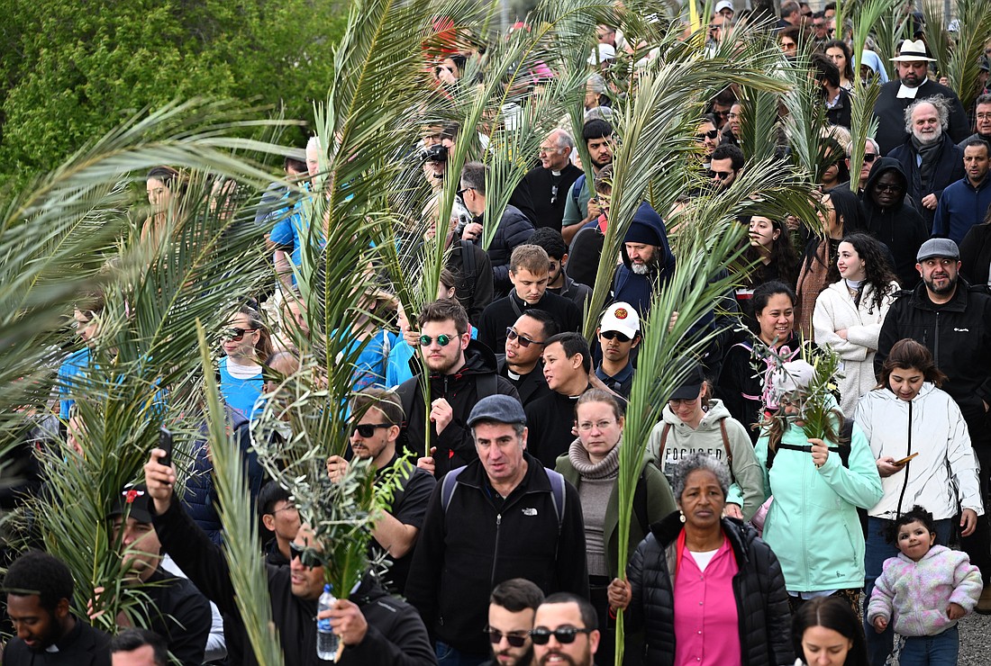 Christians wave palm and olive branches as they walk the traditional path that Jesus took on his last entry into Jerusalem during the Palm Sunday procession on the Mount of Olives in Jerusalem March 24, 2024. (OSV News photo/Debbie Hill)