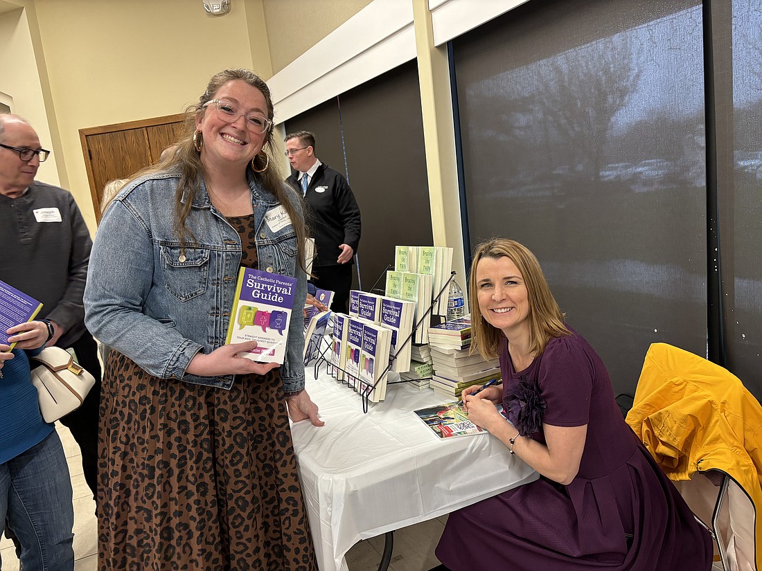 Keynotes speaker Julianne Stanz, right, autographs a copy of her book during the formation day in St. Robert Bellarmine Co-Cathedral, Freehold. Courtesy photo