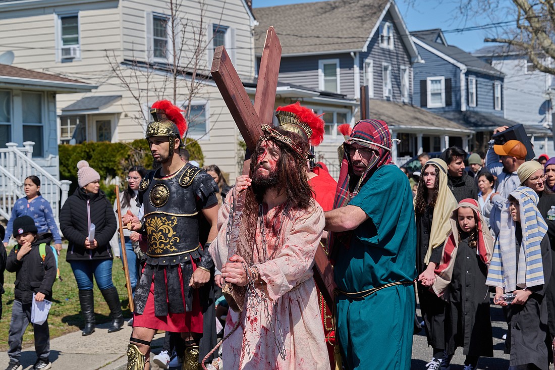 Mateo Jhow portrays Jesus as he carries his cross during the annual Living Stations of the Cross in Long Branch on Good Friday. Mike Ehrmann photo