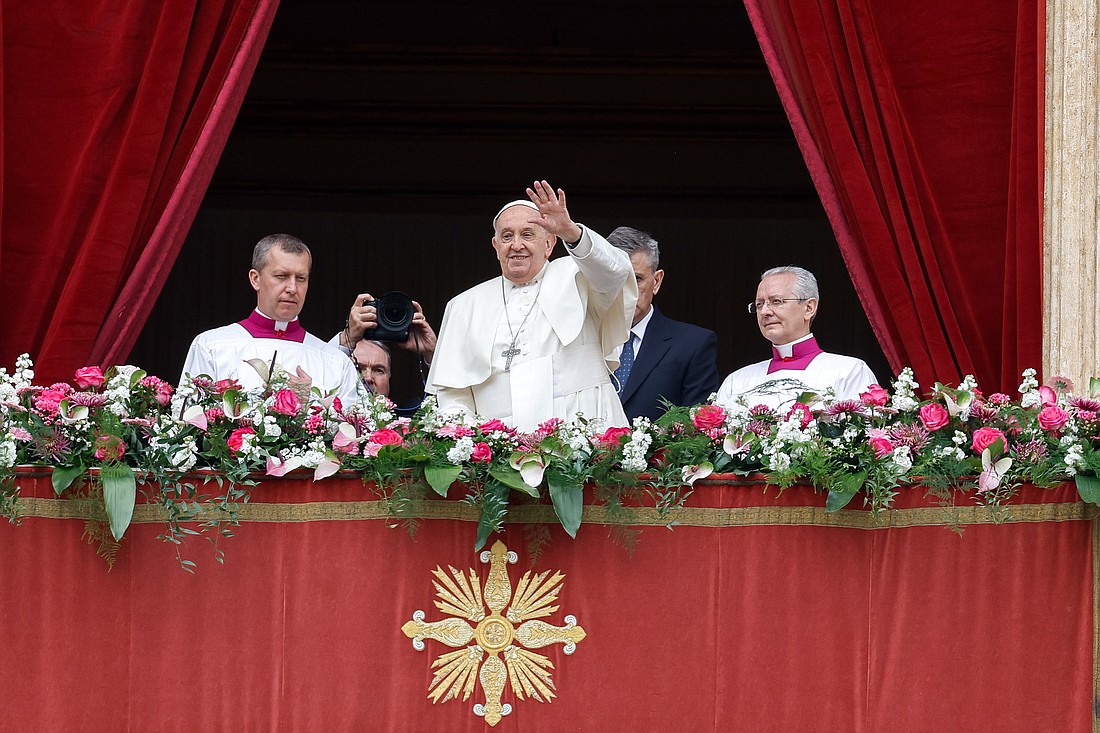 Pope Francis greets the crowd after delivering his Easter message and blessing "urbi et orbi" (to the city and the world) from the central balcony of St. Peter's Basilica at the Vatican March 31, 2024. (CNS photo/Lola Gomez)