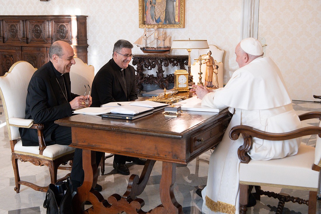 Pope Francis shares a laugh with Cardinal Víctor Manuel Fernández, right, prefect of the Dicastery for the Doctrine of the Faith, and Msgr. Armando Matteo, secretary of the dicastery's doctrinal section, during a meeting in the library of the Apostolic Palace at the Vatican Dec. 18, 2023. (CNS photo/Vatican Media)