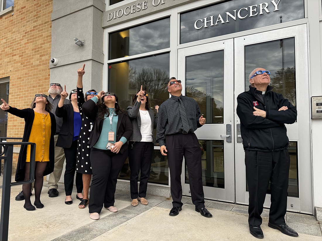 Diocesan Chancery staff view the eclipse. Marianne Hartman photo
