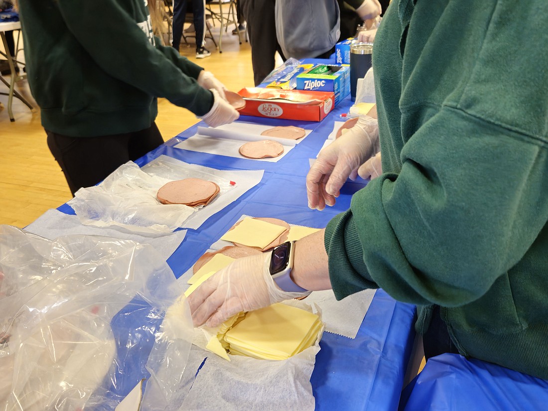 Young people from St. Mary of the Lakes Parish, Medford, participate in a Martin Luther King Day of Service effort in which they prepare sandwiches and bags of food to be given to outreach agencies in Mercer, Burlington and Camden Counties as well as in Philadelphia. Mary Stadnyk photo