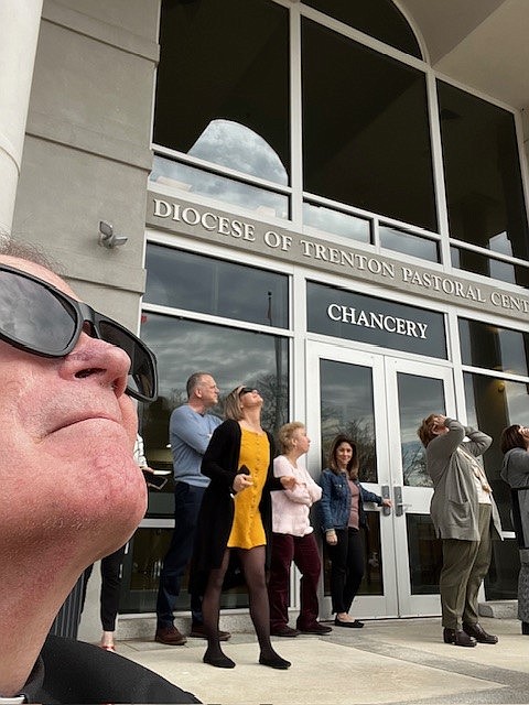 Bishop O'Connell's wearing his shades and getting in the eclipse spirit along with colleagues at the Diocesan Chancery.
