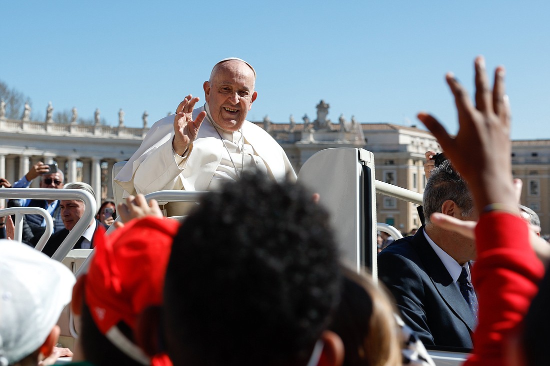 Pope Francis greets children from the popemobile as he leaves St. Peter's Square at the Vatican after his weekly general audience March 20, 2024. A new report released by the Pew Research Center April 12 shows most U.S. Catholics approve of Pope Francis -- but his ratings have slipped in the past few years, marked by political divides. (CNS photo/Lola Gomez)