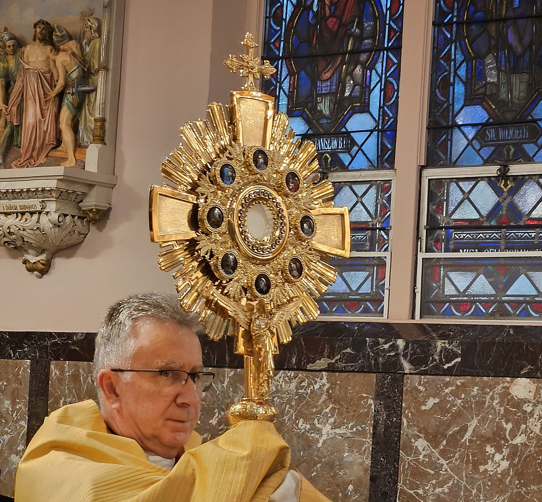 Fr. Richard Basznianin, presider, holds the Blessed Sacrament in a monstrance during an October 2023 Forty Hours devotion in St. Hedwig Church, Trenton. Mary Stadnyk photo