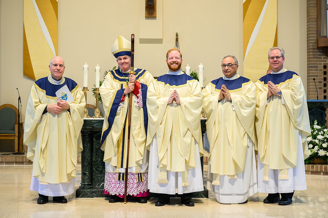 in this 2023 photo, newly ordained Father Kevin Hrycenko, third from left, stands with Bishop David M. O'Connell, C.M., and other priests following his ordination Mass in St. Joseph Church, Toms River. Personal encouragement and Eucharistic adoration are crucial in fostering vocations to the priesthood, according to data from a report released April 15 by Georgetown University's Center for Applied Research in the Apostolate. Mike Ehrmann photo