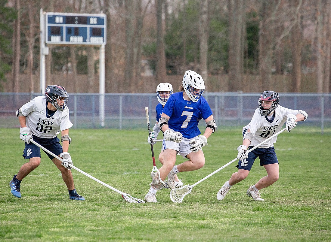 Donovan Catholic's Andrew Baltus (7) splits the Lacey defense en route to a five-goal, four-assist game against Lacey Apr. 10. Photo courtesy Lacey Boosters
