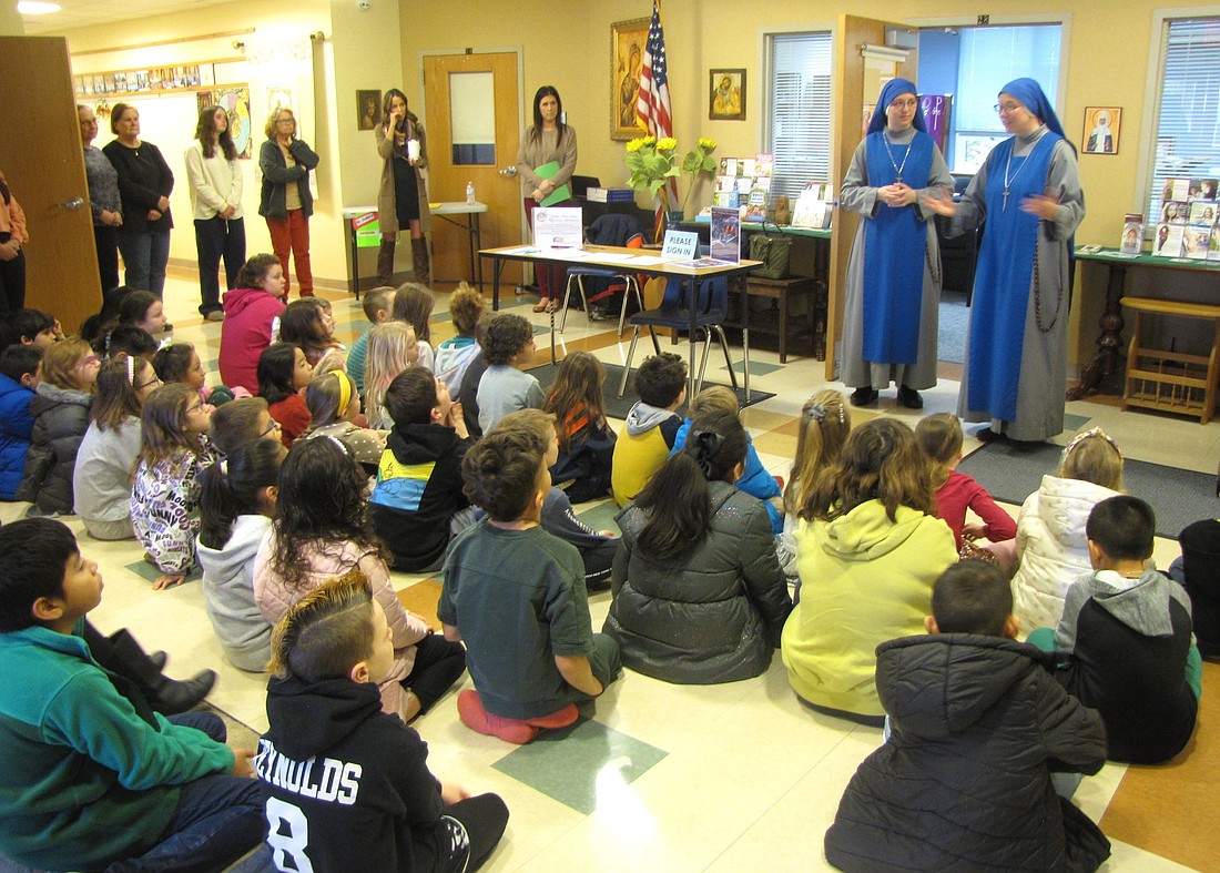 Two members of the Sister Servants of the Lord and the Virgin of Matará congregation greet religious education students at St. Jude the Apostle Parish in Lewes, Del. During their visit Feb. 4-5, 2024, they talked about their call to a religious vocation, how they live and what it's like to be a nun. It was the first time some of the students had ever seen a nun. (OSV News photo/courtesy St. Jude’s parish)