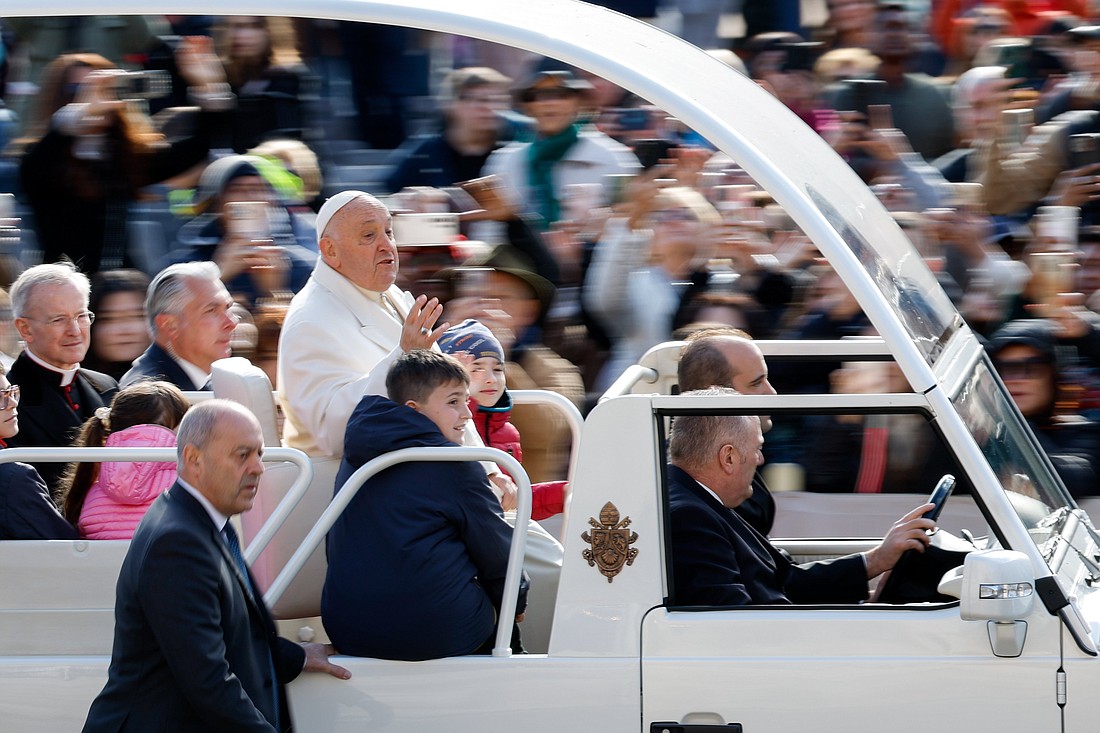 Pope Francis greets visitors as he rides the popemobile around St. Peter's Square at the Vatican before his weekly general audience April 24, 2024. (CNS photo/Lola Gomez)