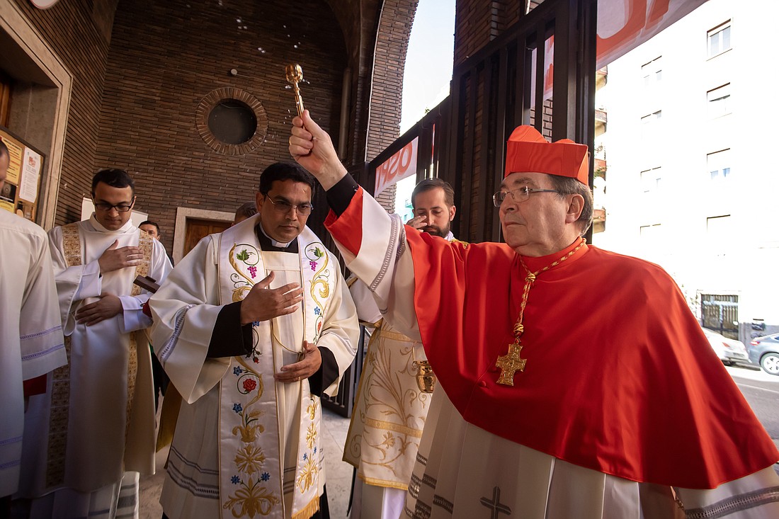 French Cardinal Christophe Pierre, apostolic nuncio to the United States, sprinkles holy water before celebrating Mass in Rome April 21, 2024, to formally take possession of his titular church, the Church of St. Benedict Outside St. Paul's Gate. CNS photo/Pablo Esparza