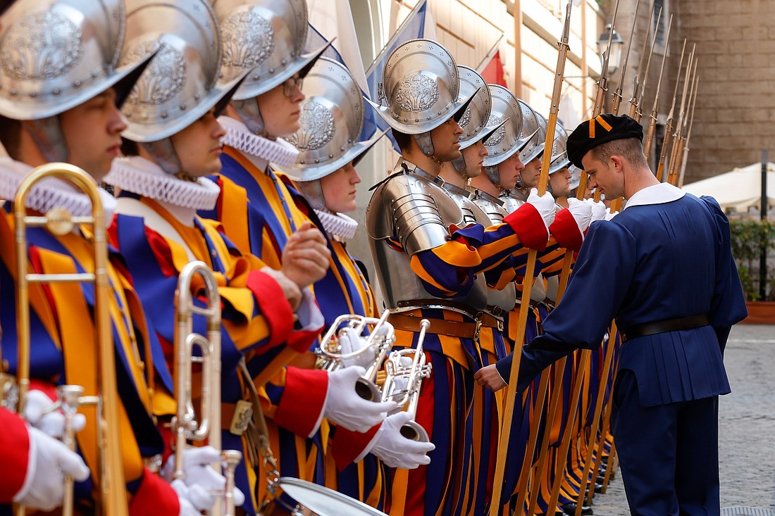 New recruits of the Pontifical Swiss Guard stand at attention while an officer inspects their uniforms during a training session at the Vatican April 30, 2024, ahead of their swearing-in ceremony May 6. (CNS photo/Lola Gomez)