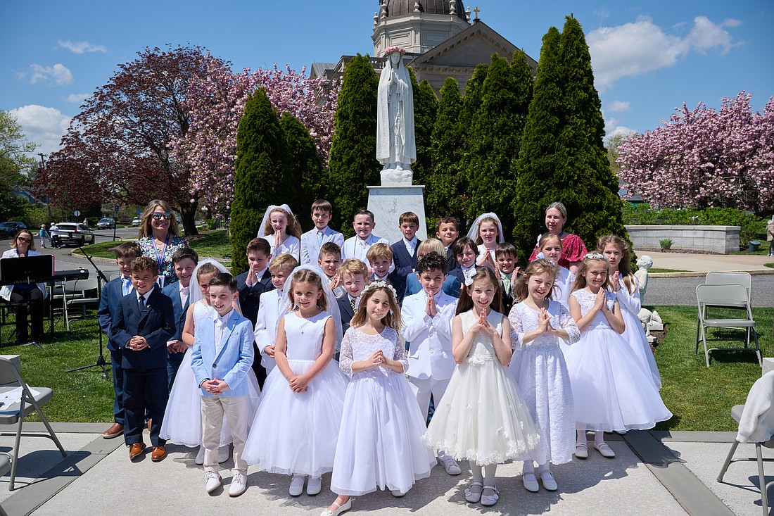 First Holy Communion students in St. Catharine School, Spring Lake, stand before the newly crowned statue of the Blessed Virgin Mary May 1. Mike Ehrmann photo