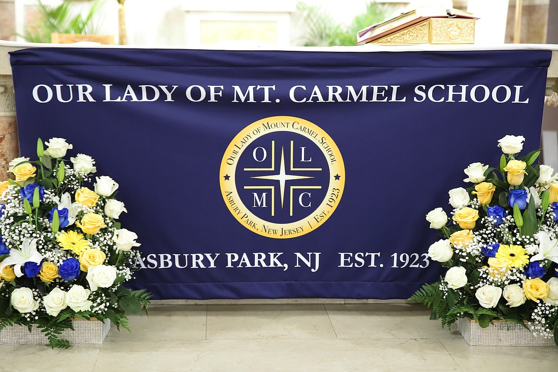 Shown is a large banner noting Our Lady of Mount Carmel School's centennial anniversary. John Batkowski photo