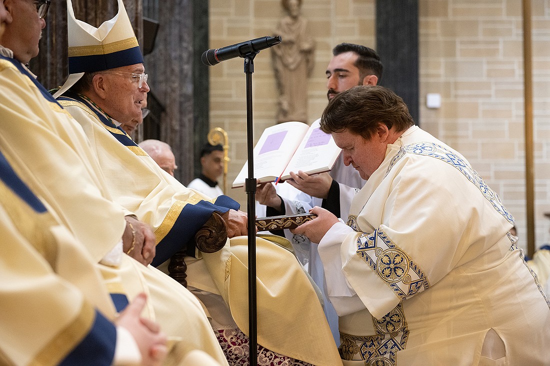 Rev. Mr. Brian Meinders receives the Book of the Gospels during the diaconate ordination rite May 2023.  Jeff Bruno photo