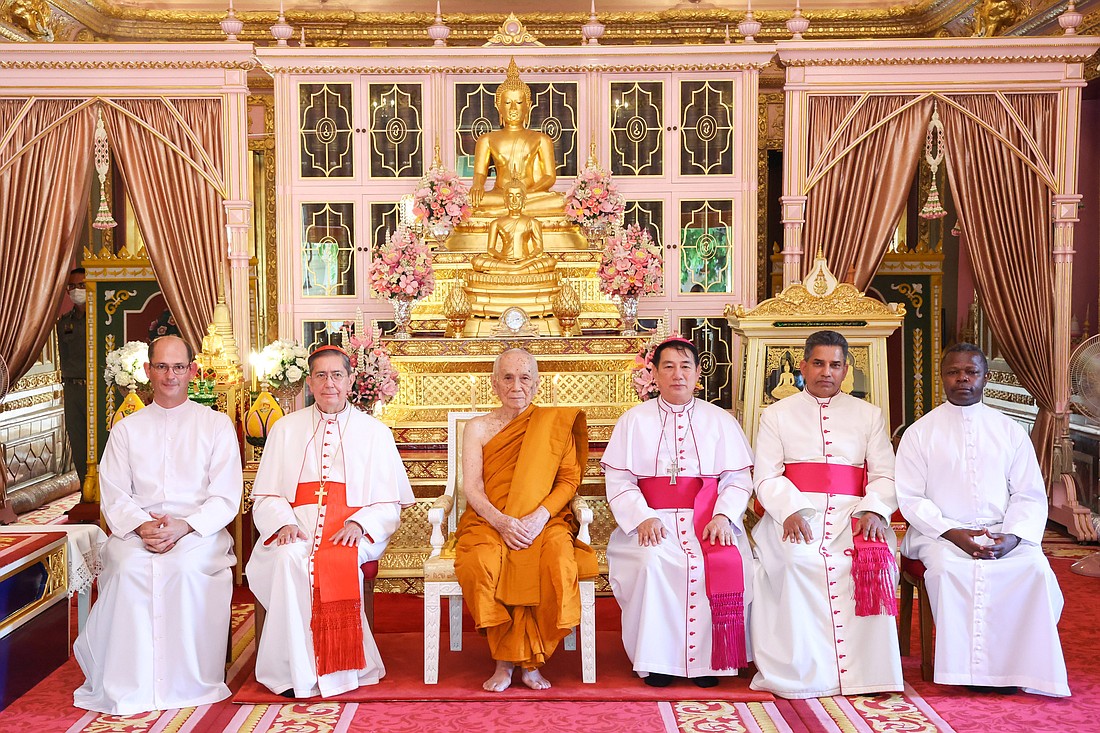 Cardinal Miguel Ángel Ayuso Guixot, prefect of the Dicastery for Interreligious Dialogue, second from the left, poses for a photo with a Vatican delegation at the Grand Palace in Bangkok, Thailand, Nov. 17, 2023. In the middle, seated next to the cardinal is Ariyavongsagatanana IX, supreme patriarch of Thailand and head of the order of Buddhist monks in Thailand. (CNS photo/courtesy of Dicastery for Interreligious Dialogue)..