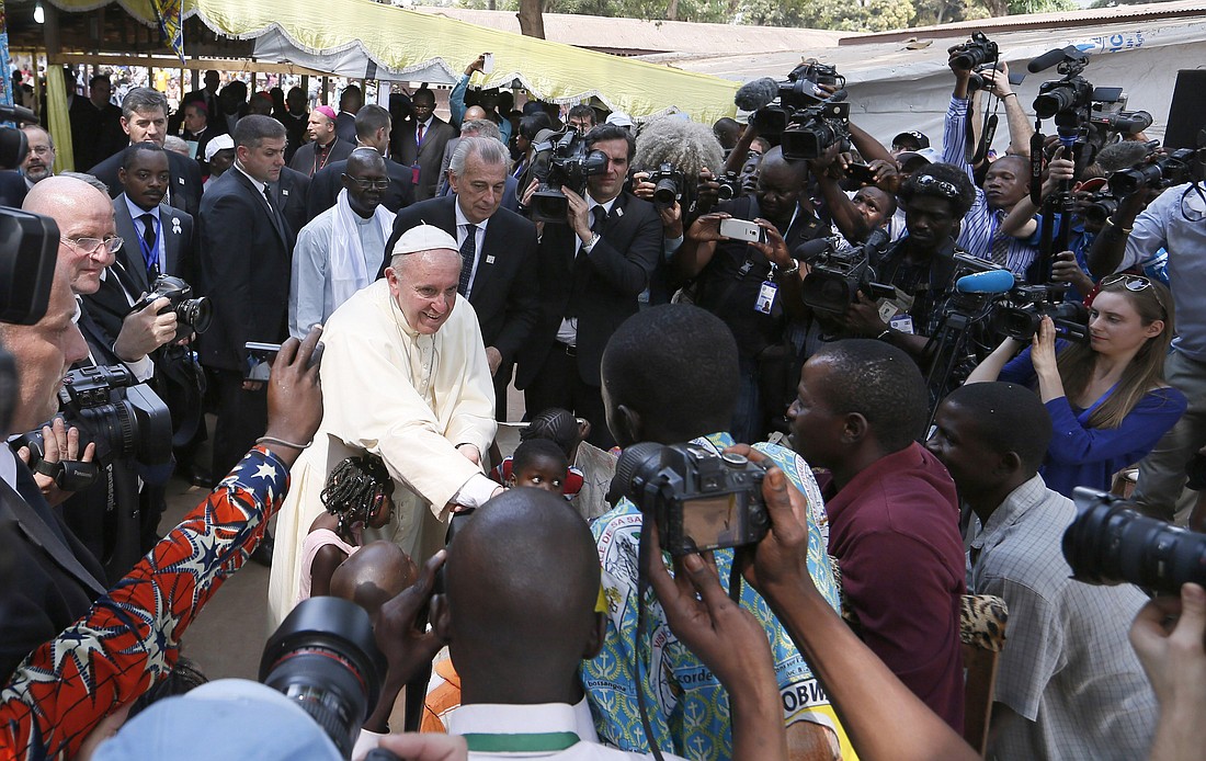 Pope Francis is surrounded by media as he greets people at a refugee camp in Bangui, Central African Republic, Nov. 29, 2015. (CNS photo/Paul Haring)