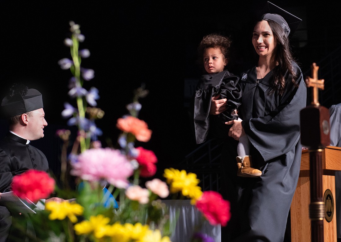 Katie Chihoski smiles after receiving her degree with her daughter, Lucia, in her arms during her graduation ceremony at the University of Mary in Bismarck, N.D., April 27, 2024. She is the first graduate of the Catholic school's St. Teresa of Calcutta Community for Mothers. (OSV News photo/courtesy University of Mary)