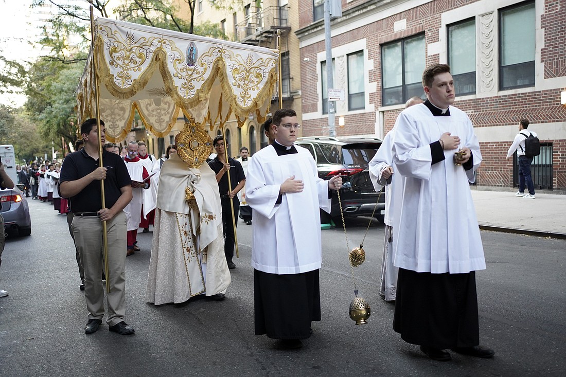 Father Roger Landry, chaplain at Columbia University, holds a monstrance containing the Blessed Sacrament during a Eucharistic procession in New York City Oct. 11, 2022. Father Landry may be the reason 24 young people and several priests are walking thousands of miles across the U.S. this summer during the National Eucharistic Pilgrimage. (OSV News photo/Gregory A. Shemitz)