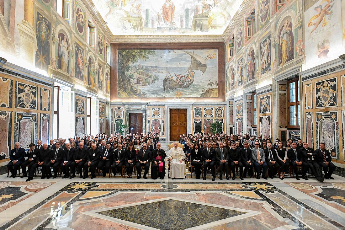 Pope Francis poses for a photo with teachers and students from the Vatican School of Paleography, Diplomatic and Archival Studies and the Vatican School of Library Studies during a meeting at the Vatican May 13, 2024. (CNS photo/Vatican Media)