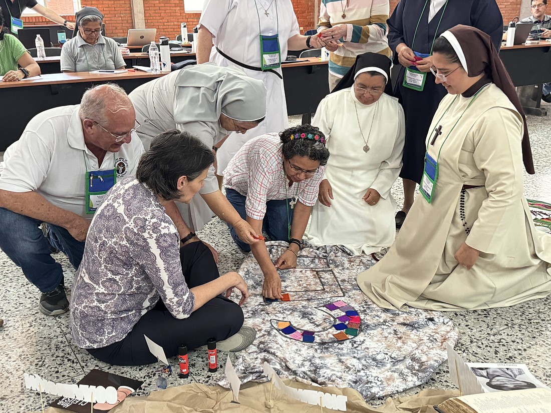 Members of the Confederation of Latin American and Caribbean Religious, or CLAR, put together an altar decoration April 18, 2024. at the Catholic University campus in Las Tres Rosas, Honduras. Some 60 general secretaries, presidents of religious conferences and theologians representing the board of the largest organization of women and men religious in Latin America and the Caribbean gathered for CLAR's annual meeting April 18-21 to talk about consecrated life in the region. (GSR photo/Rhina Guidos).