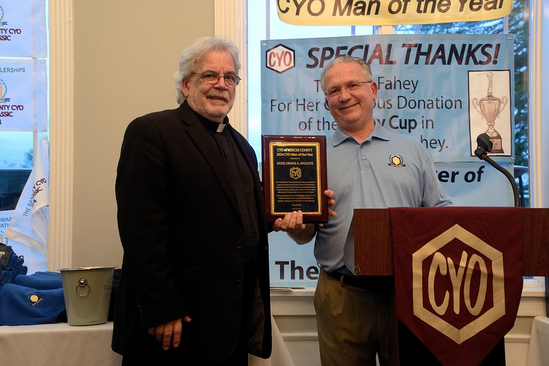 Tom Mladenetz, right, CYO executive director, presents the 2024 CYO Man of the Year Award to Msgr. Dennis Apoldite during the CYO's May 16 golf outing. Joe Moore photo