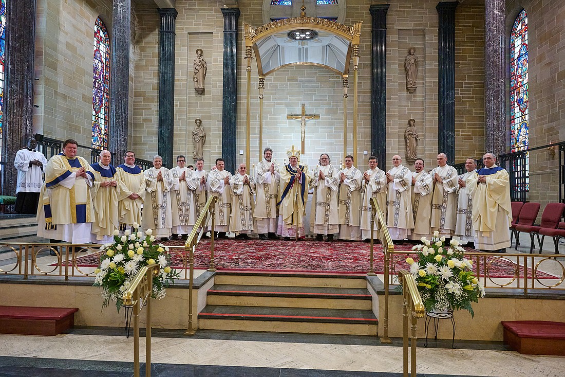 Bishop O'Connell is pictured with the 13 new deacons of the Diocese following the May 18 Mass of Ordination in St. Mary of the Assumption Cathedral, Trenton. Also pictured from far left are Rev. Mr. Brian Meinders, a transitional deacon for the Diocese who is expected to be ordained a priest on June 1; Msgr. Thomas Mullelly, episcopal vicar of Clergy and Consecrated Life and director of Seminarians, and Father Christopher Colavito, diocesan director of vocations and director of the diocesan diaconate formation program. At far right is Msgr. Thomas N. Gervasio, diocesan vicar general and moderator of the curia. Mike Ehrmann photo