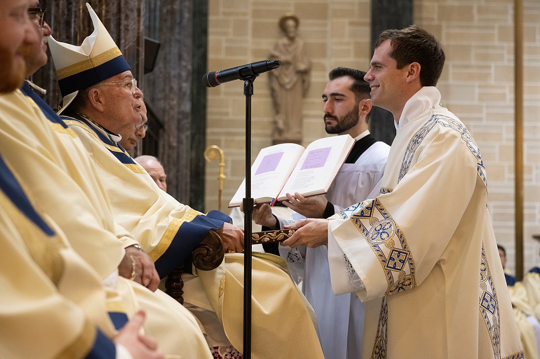 Rev. Mr. Wynne Kerridge receives the Book of the Gospels during the diaconate ordination rite May 2023. Jeff Bruno photo