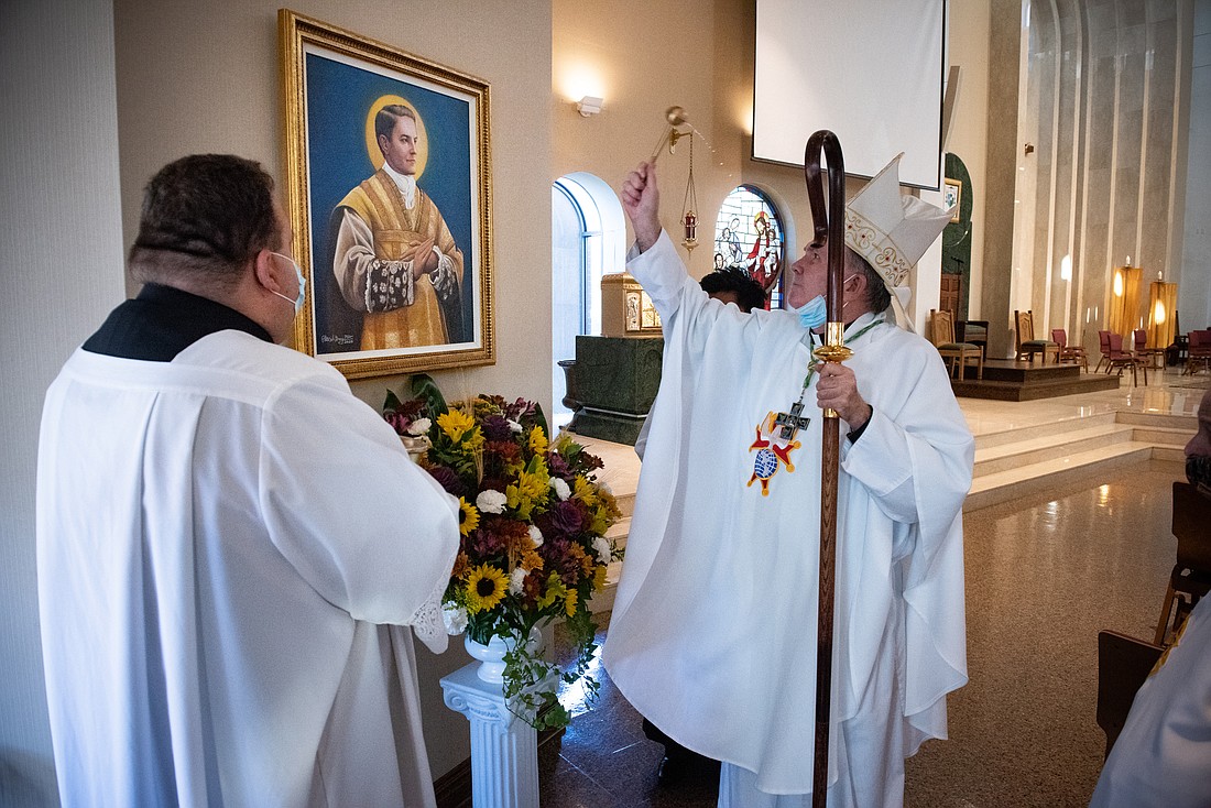 In this file photo, Bishop David M. O'Connell, C.M., blesses a portrait of Blessed Michael J. McGivney during a diocesan observance of Blessed McGivney's 2020 beatification. Jeff Bruno photo