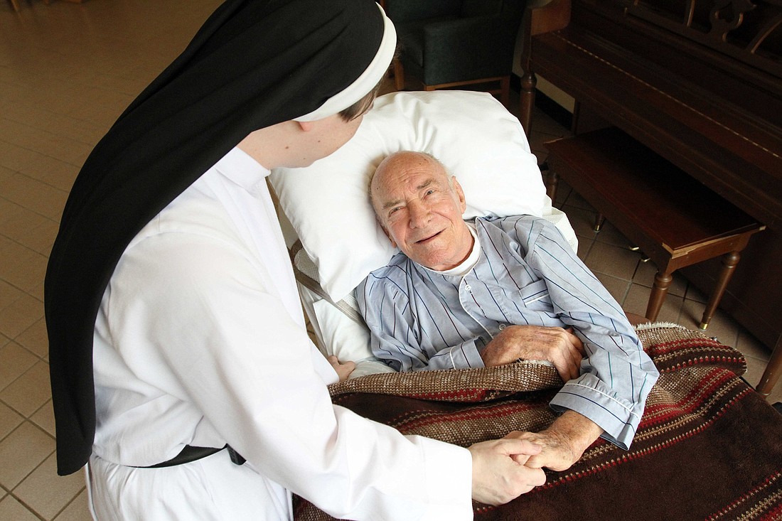 A patient is pictured in a file photo chatting with Dominican Sister Catherine Marie at Rosary Hill Home, a Dominican-run facility in Hawthorne, N.Y., that provides palliative care to people with incurable cancer and are in financial need. OSV News photo/Gregory A. Shemitz.