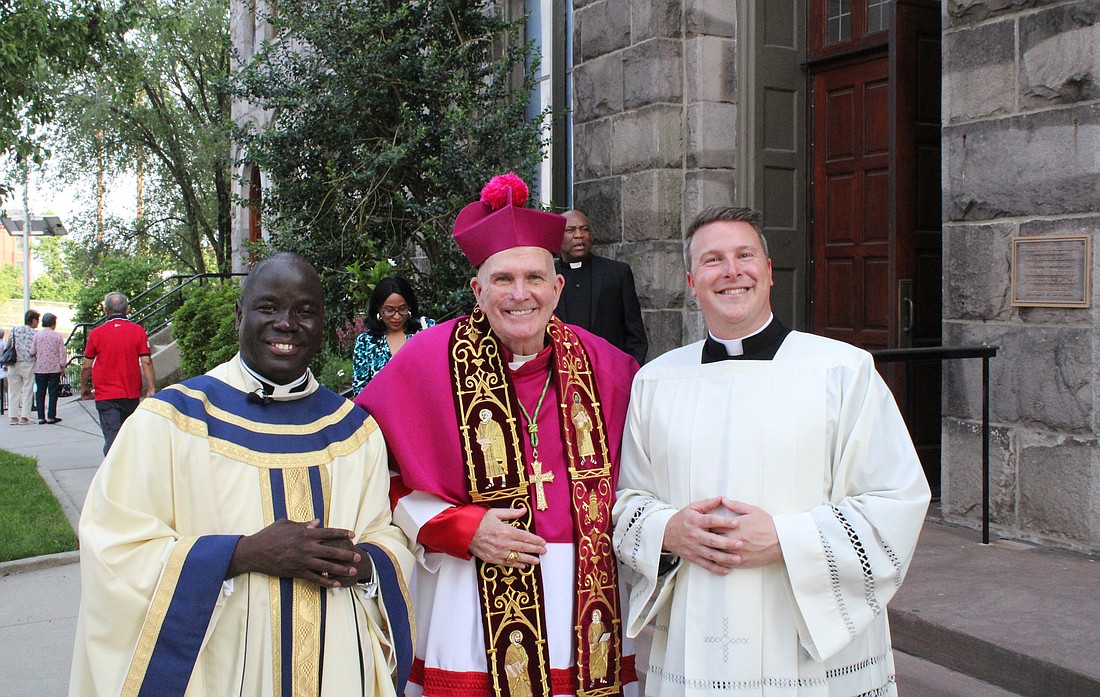 After Mass, Father Felicien poses for a photo with Bishop David M. O'Connell, C.M., and Father Christopher Dayton, administrator of St. Paul Parish, Princeton. Trey Taylor-Norwood photo