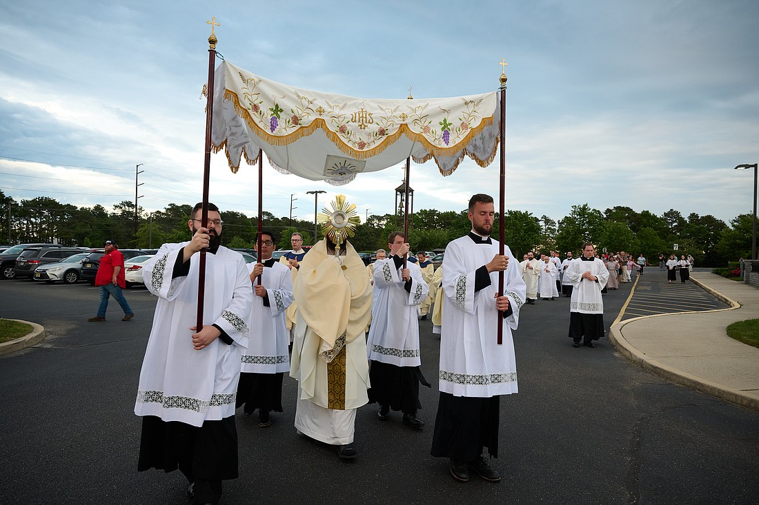 A Eucharistic procession with the Seton Route pilgrims' monstrance moves from St. Mary of the Pines Church where Bishop O'Connell celebrated Mass to the parish center where Adoration was held. Mike Ehrmann photo