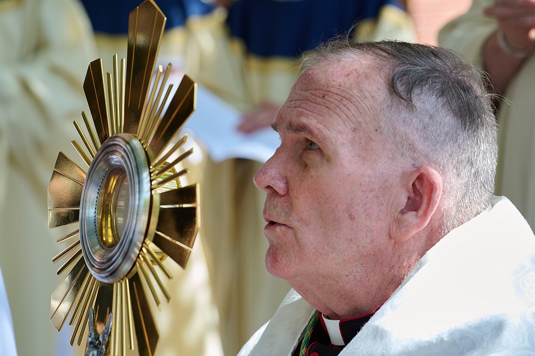 Bishop O'Connell holds the monstrance being used by the Seton route pilgrims during the Diocese's three-day Eucharistic Revival observance. Father Garry Koch reflects on the Solemnity of the Most Holy Body and Blood of Jesus by emphasizing on the importance of receiving the Sacraments which includes the Eucharist. Mike Ehrmann photo