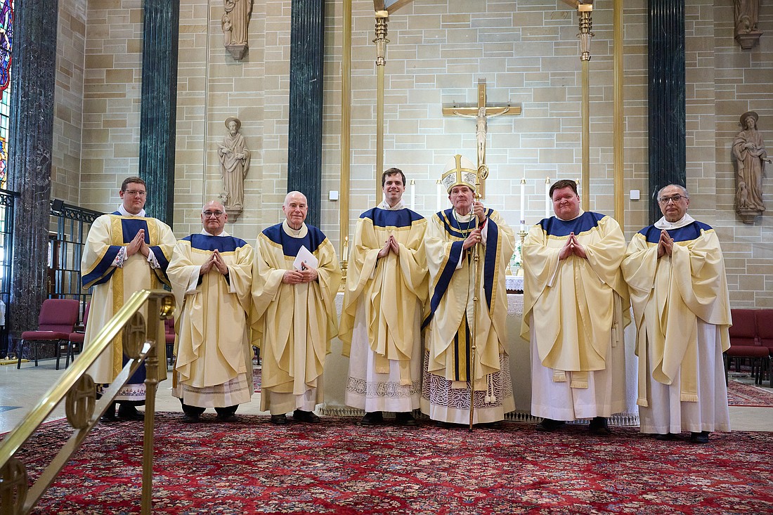 Father Wynne Kerridge, fourth from left, and Father Brian Meinders, second from right, pose for their first photo as new priests with Bishop O'Connell following their June 1 Mass of Ordination. Also pictured are, from left, Rev. Mr. Alan Bridges, a transitional deacon who is expected to be ordained a priest next May; Msgr. Joseph Roldan, Cathedral rector, and Msgr. Thomas Mullelly, diocesan vicar for clergy and consecrated life and director of seminarians. At right is Msgr. Thomas Gervasio, diocesan vicar general. Mike Ehrmann photo
