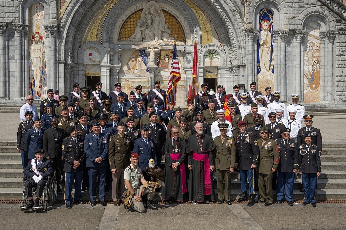 U.S. military members of the Warriors to Lourdes program in an undated photo pose on the steps of the Rosary Basilica at the Sanctuary of Our Lady of Lourdes in France with Archbishop Timothy P. Broglio of the U.S. Archdiocese for the Military Services, center, and Bishop Scott McCaig, head of the Military Ordinariate of Canada (with beard). (OSV News photo/Tamino Petelinsek, courtesy Knights of Columbus)