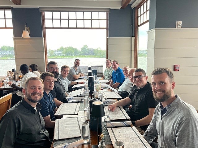 Seminarians of the Diocese, along with Bishop O'Connell and several priests, enjoy an evening dinner at the Jersey Shore during the seminarians' annual retreat July 3-7. Staff photo