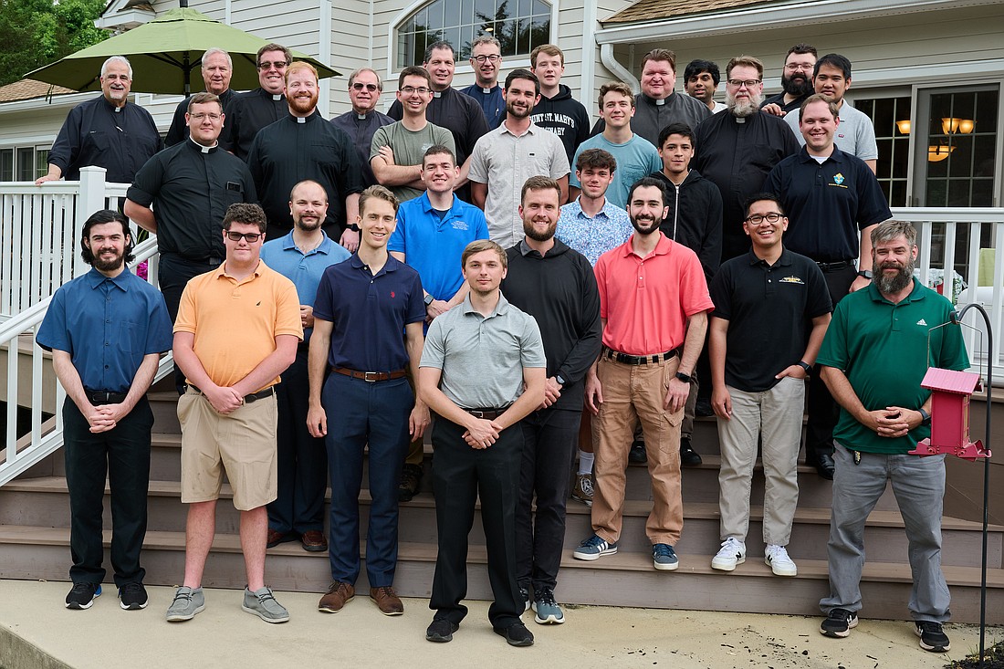 Men attending a June 11 vocation discernment event gather for a group photo with diocesan priests and seminarians outside the rectory of St. Robert Bellarmine Co-Cathedral, Freehold. Mike Ehrmann photo