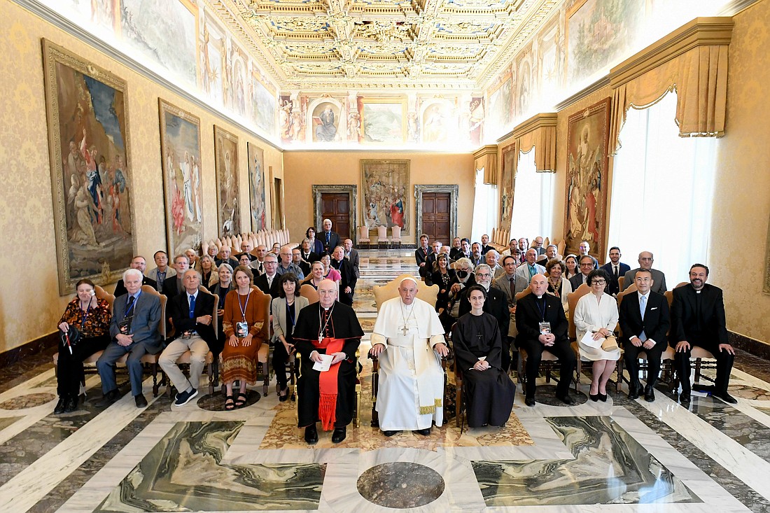 Pope Francis poses for a photo with cosmologists, theoretical physicists and scientists taking part in a conference about black holes and gravitational waves during a private audience at the Vatican June 20, 2024. He is seated between Cardinal Fernando Vérgez Alzaga, president of the commission governing Vatican City State, and Sister Raffaella Petrini, secretary-general of the commission and a member of the Franciscan Sisters of the Eucharist. (CNS photo/Vatican Media)