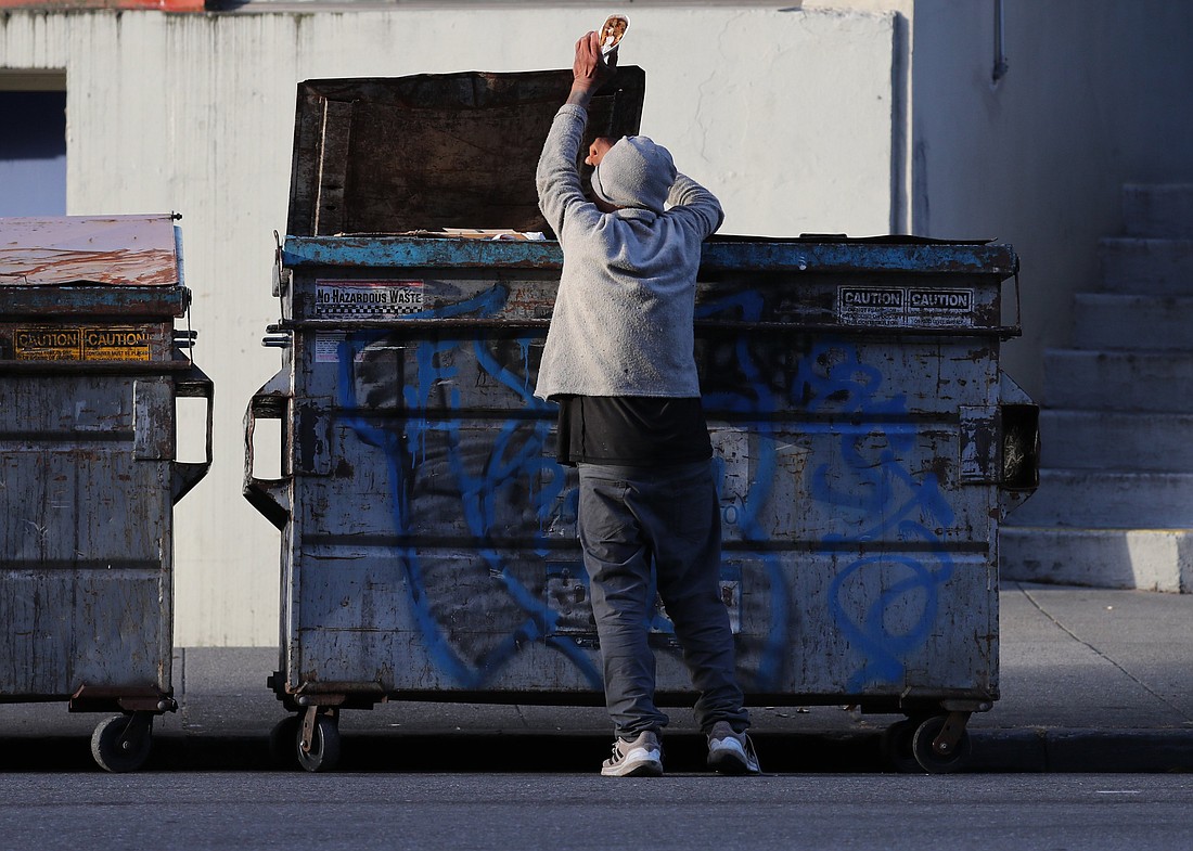 A man pulls food out of a dumpster in San Francisco May 19, 2024. The needs of the homeless and other vulnerable groups in the U.S. have been among the concerns of the U.S. bishops' Catholic Campaign for Human Development as it has provided grants, through an application process, to groups that address societal issues. Other target projects of CCHD, founded in 1970, have included voter registration, credit unions, job training programs, cooperatives and nonprofit housing corporations. (OSV News photo/Bob Roller)