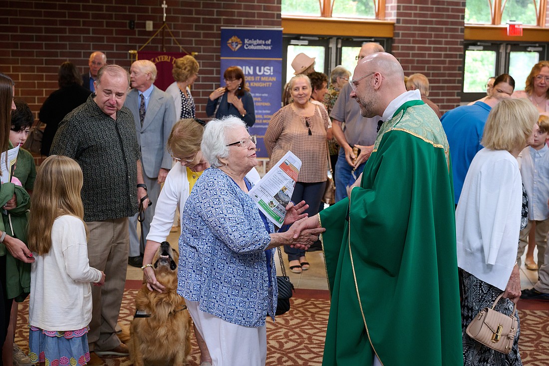 Father James Smith greets parishioners following the June 30 Mass during which he was installed as pastor of St. Isaac Jogues Parish, Marlton. Mike Ehrmann photo