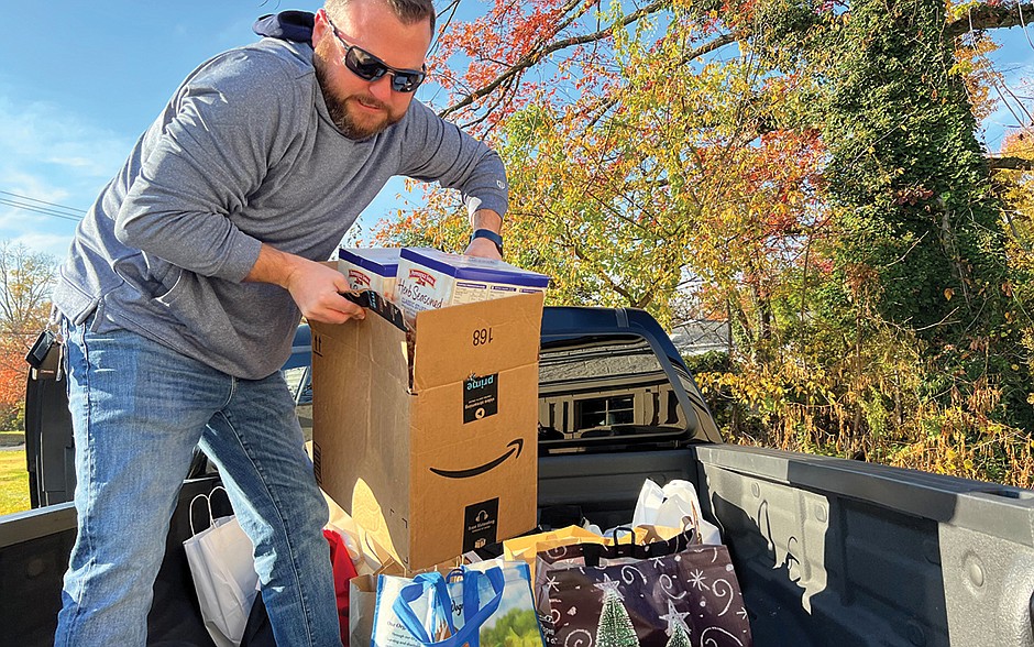 A volunteer with the St. Vincent de Paul conference in Our Lady of Good Counsel Parish packs a truck with food to be delivered to the area food pantries. Courtesy photo