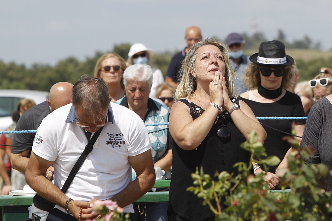 Gisella Cardia kneels and looks skyward Aug. 3, 2020, in the moment devotees claim Mary appeared to her and revealed a message. The alleged apparitions have taken place in Trevignano Romano, Italy. (CNS photo/Robert Duncan)