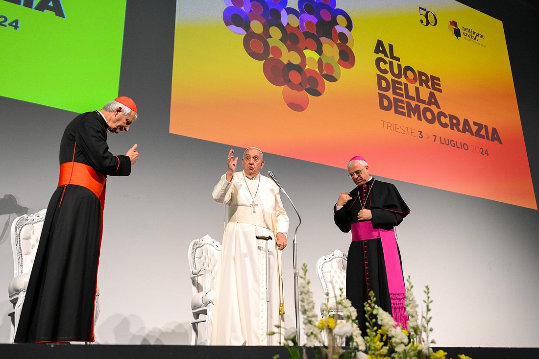 Pope Francis gives his blessing at the Generali Convention Center in Trieste, Italy, for an event during Italian Catholic Social Week July 7, 2024. Also in the photo are Cardinal Matteo Zuppi, president of the Italian bishops’ conference, left, and Archbishop Luigi Renna of Catania, Italy, right. (CNS photo/Vatican Media)