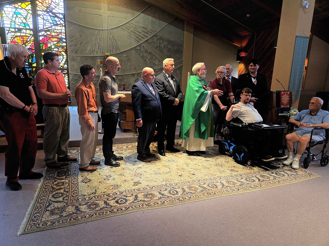 Father Brian Butch, pastor of St. Anselm Parish, Tinton Falls, is shown with members of the Knights of Columbus during Mass June 9 in which he received the Blessed Michael McGivney Chaplain of the Year Award. Courtesy photo