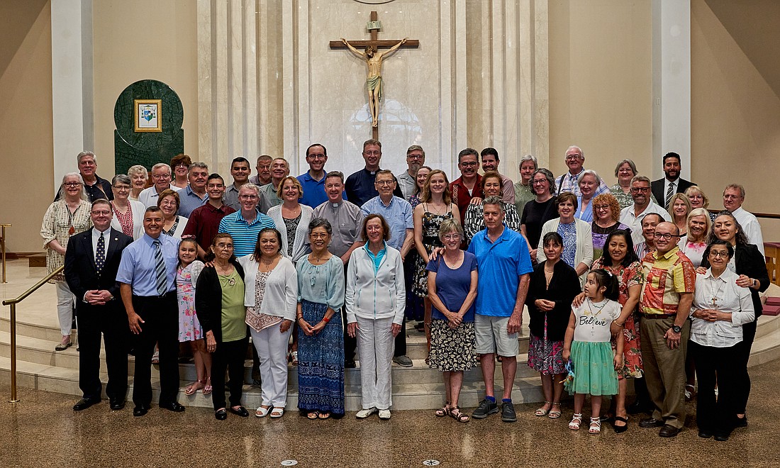 After Mass, the Eucharistic Congress pilgrims, along with their family members, and Father O'Reilly, back row center, pose for a group photo in the sanctuary of St. Robert Bellarmine Co-Cathedral, Freehold. Vic Mistretta photo