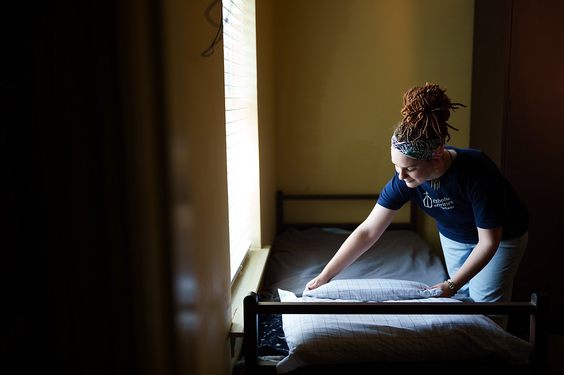 A case worker with Catholic Charities of Acadiana is pictured in a file photo preparing a bed at St. Joseph Shelter, an emergency shelter that cares for 87 individuals experiencing homelessness in and around Lafayette, La. (OSV News photo/Jason Cohen, courtesy Catholic Charities of Acadiana)